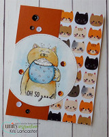 Handmade card with a tan cat holding a blue polka-dot mug in a stitched circle, orange panel, cat-face patterned paper and the sentiment 'Oh so good'