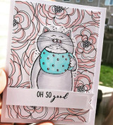 Card with a grey cat hugging a teal polka-dot mug over pink line-art peonies, with the sentiment 'Oh so good' on a banner