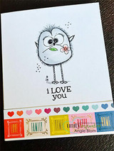 White card with a green bird holding a flower, 'i LOVE you,' rainbow strip.