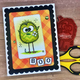 Orange plaid card with a green crazy bird, 'BOO.'