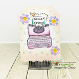 Tag with the typewriter colored pink and surrounded by tiny flowers, 'hello friend'