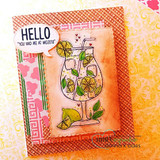 Orange and pink layered card with the mojito glass watercolored in warm citrus tones, small hearts, and a speech bubble reading "you had me at mojito."