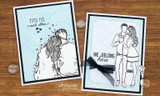 Handmade card featuring the tender AngieGirl couple embracing, softly inked on white, stamped with 'Capture the moment'.