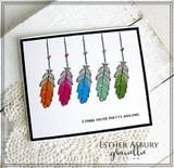 A row of rainbow-colored hanging feathers on a white card, reading 'I think you're pretty amazing.'