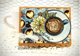 The coffee cup with a yellow flower on a card over a chicken-wire background.