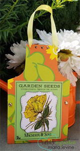 Bright green and orange paper gift bag stamped with the Garden Seeds packet and a yellow bloom, filled with white daisies.