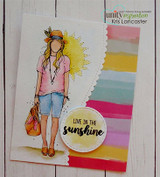 Handmade card featuring the free-spirited AngieGirl strolling with her bag, against colorful stripes, stamped with 'Live in the sunshine'.