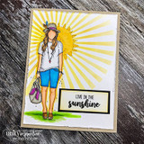 Handmade card featuring the free-spirited AngieGirl strolling with her bag, in a soft yellow sunbeam scene, stamped with 'Live in the sunshine'.