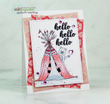 Card on red floral paper with the teepee colored pink and red, a white bear, and 'hello' stamped three times.