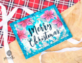 Card with pink poinsettias on a teal panel and 'Merry Christmas.'