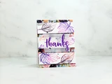 A small floral card with leaves outlined in purple and 'thanks' stamped in purple on a vellum strip.