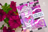 Pink-toned cards photographed with fresh petunias, coffee cup images and a 'stay strong' sentiment.