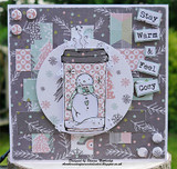 Angie Blom's snowman inside a holiday travel coffee mug with 'Stay warm & feel cozy,' a red rubber winter stamp shown on a card.