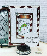 Angie Blom's snowman inside a holiday travel coffee mug with 'Stay warm & feel cozy,' a red rubber winter stamp shown on a card.