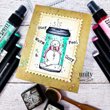Angie Blom's snowman inside a holiday travel coffee mug with 'Stay warm & feel cozy,' a red rubber winter stamp shown on a card.