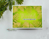 Lime green ombre card with gold and pale leaf prints stamped around the border, Thankful for your friendship in white and gold at the center, greenery resting alongside.