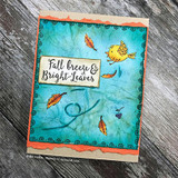 Teal crinkled card with an orange frame, tumbling autumn leaves, a yellow bird and a panel reading Fall breeze and Bright Leaves.