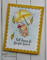 Golden scalloped-frame card with the bunny under a yellow umbrella and drifting leaves, above the script sentiment Fall breeze and Bright Leaves.