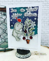 Navy watercolor card with the bear decorating a snowy tree beside the small dog.