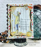 Card styled on a black stand with a pumpkin and chicken wire, the girl coloured in a pale green coat against a striped background, autumn leaf borders and the autumn tree sentiment.