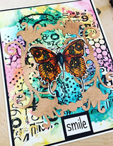 Bright mixed media card with the honeycomb, a kraft flourish frame, an orange butterfly and a smile label