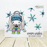 Bunny in a blue hat with rainbow striped boots among glittery teal snowflakes on a white card with 'warm wishes this holiday season'.