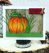 Card with the barn wall behind a die-cut pumpkin patch: 'Feel the warmth.'