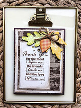 Framed card with the barn wall behind fall leaves: 'Thank you for the food before us, the friends beside us, and the love between us.'