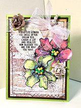 Mixed-media card with the barn wall behind painted flowers: 'A good life is when you smile often, dream big, and laugh a lot.'
