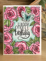 Pink roses framing a mint center with a stamped birthday greeting and a die cut butterfly on a white card.