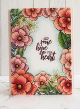 Card with the floral border colored in coral and green watercolor framing 'Keep some hope in your heart.'