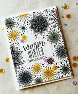 Handmade card featuring the bursting snowflake medallions filling an A2 background, in icy blues and golds, stamped with 'Warm Winter Blessings'.