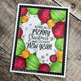 Black scalloped card with the ornament border in red, green and orange, centered with a bold sentiment reading We wish you a Merry Christmas and a Happy New Year.