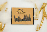Kraft card of the pine tree line, 'Merry Christmas.'