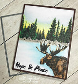 Card of a moose before a green pine forest and lake, 'Hope & Peace.'