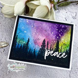 Galaxy-washed card of the pine tree line under northern lights, 'peace.'