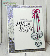 Handmade card featuring the strand of jingle bells and a sprig of holly berries, with silver glitter accents, stamped with 'Merry Christmas'.