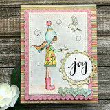 Card with the sketched winter girl among snowflakes, stamped 'joy.'