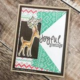 Card with green chevron and brown colour blocked panels on wood, a fawn coloured in soft tan with berry antlers and a script joyful greeting beside it.