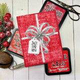 Red card with the 'Merry Christmas' word background embossed behind a stamped bow gift, tagged 'just for you.'