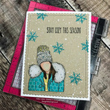 Teal snowflake card of the bundled girl with 'STAY COZY THIS SEASON.'