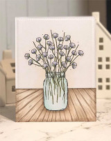 White card with the mason jar of sketched cotton stems on a sunburst wood-toned base