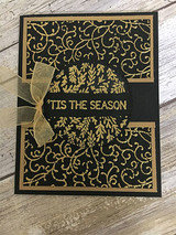 The flourish background in gold on black with a sheer bow — ''Tis the Season.'
