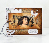 Sepia cherub on a scrolled brown card with a white butterfly and the tag 'blessings to you this holiday season'