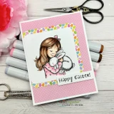 Card framed in egg-print paper with the girl in a pink dress holding her bunnies; the Easter greeting shown is from another set.