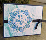 Blue daisies circling you are the best on marbled teal card with black ribbon