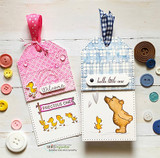 Two baby gift tags in pink and blue with the ducklings and bear stamped and colored, reading 'Welcome', 'PRECIOUS ONE' and 'hello little one', surrounded by buttons.