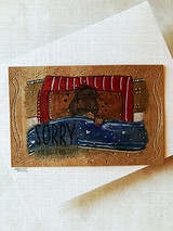 Card with the girl under a red-and-blue blanket framed on kraft, sentiment 'SORRY you had a bad day.'