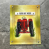 Red vintage tractor, 'OLDER BUT WISER,' on a golden distressed background.