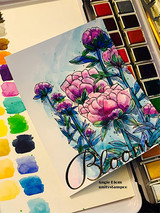 Watercolored card with the peonies in pink and purple beside a paint palette, stamped 'Bloom.'